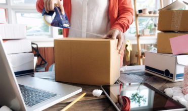 Woman using a box to resell customer returns