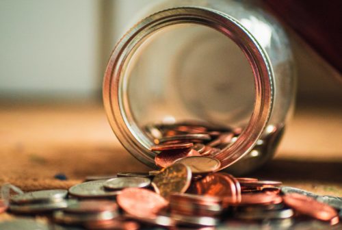 6 Hidden Sourcing Costs and How to Avoid Them Jar with coins spilling out of it
